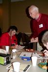 Stephen Carls, university professor of history and department chair, hands out information about the history department to new students during the Dinner with your Department event. - Photo by Deanna Santangelo