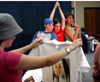 Freshmen Cassie Harris, Lindsey Abell, and Gina Orosz strike a Charlie's Angels pose for a personalized t-shirt at Fall Fest 2003. Freshman Chelsea Mytyk looks at her nun like t-shirt that was just made. - Photo by Jonathan Blair