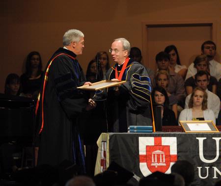 President David S. Dockery presents Doug Walker, associate vice president for advancement and executive director of the Union Foundation, with a plaque in honor of his new role at the university. 