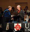 President David S. Dockery presents Thomas R. Rosebrough, university professor of education and executive dean of the college of education and human studies, with a plaque in honor of his new role at the university.  - Photo by Morris Abernathy