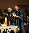 President David S. Dockery presents Richard Wells, vice president for church relations, with a plaque in honor of his new role at the university.  - Photo by Morris Abernathy