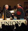 President David S. Dockery presents Jerry Tidwell, senior vice president for university relations, with a plaque in honor of his new role at the university.  - Photo by Morris Abernathy