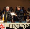 President David S. Dockery presents Gene Fant, vice president for academic administration and dean of the college of arts & sciences, with a plaque in honor of his new role at the university. - Photo by Morris Abernathy