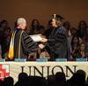 President David S. Dockery presents Carla Sanderson, provost and executive vice president, with a plaque in honor of her new role at the university. - Photo by Morris Abernathy