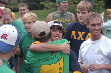 Surrounded by his new fraternity brothers and associate members freshman Bryan Spillman, Christian Studies major, embraces his friend sophomore Josh Hogue, Biblical studies major, after picking up his bid on Friday.