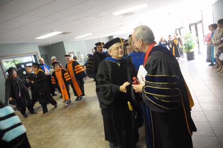 President David S. Dockery greets James Huggins, university professor of biology, after the Fall Convocation service. 