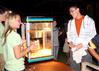 Becka Johnson, junior nursing major, helps hand out popcorn at Movie on the Lawn. - Photo by Ebbie Davis