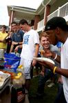 Luke Pruett, residence director, cheers on Michael Brown, sophomore social work major, during a pancake eating contest at the Watters Great Outdoors competition. - Photo by Deanna Santangelo