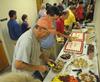 Members of the facilities and information technology teams fill their plates at a reception in their honor. - Photo by Morris Abernathy