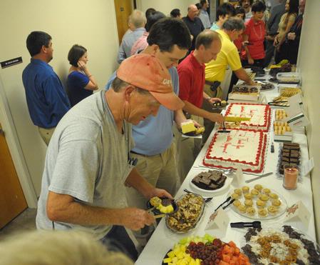 Members of the facilities and information technology teams fill their plates at a reception in their honor.
