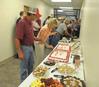 David McIntire and Mary Brown, secretary in facilities management, fill their plates at the reception honoring those that worked hard during the remodel of the Penick Academic Complex.  - Photo by Morris Abernathy