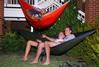 Students recline in hammocks while at the first Movie on the Lawn of the semester. This event is hosted by SAC and takes place in the residence quad areas.  - Photo by Abigail Harris