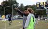 Clovas Siman, men's soccer coach, gives William Hanna, senior sports management major, some instruction on the sidelines during a game against Mid-Continent University.  - Photo by Ebbie Davis