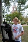 Lauren Sprouse, sophomore psychology major, draws with charcoal for a drawing class held outside in The Grove. - Photo by Morris Abernathy