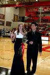 Emily Logan, senior music performance major, is escorted by her brother-in-law, Danny Song, during the presentation of the homecoming court.  - Photo by Deanna Santangelo