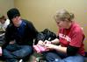 Jeff Paul, sophomore English major, and Calee Clark, sophomore chemistry major, wrap presents to be given to a 12 year old girl at the Carl Perkins Christmas Party. - Photo by Deanna Santangelo