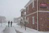 Students leave their cozy dorms to trek across campus in the snow. - Photo by Morris Abernathy