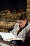 Jessica Shubert, senior nursing major, studies by the fire in the Bowld Student Commons.  - Photo by Beth Spain