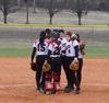The softball team huddles together before fielding in a game against Christian Brothers University. The Lady Bulldogs won both games in the double header.  - Photo by Victoria Stargel