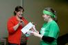 Ema VanCleave, residence director of female quads, gives Angela Patterson, senior social work major, a clue for the Residence Life event, the Amazing Race.  - Photo by Deanna Santangelo