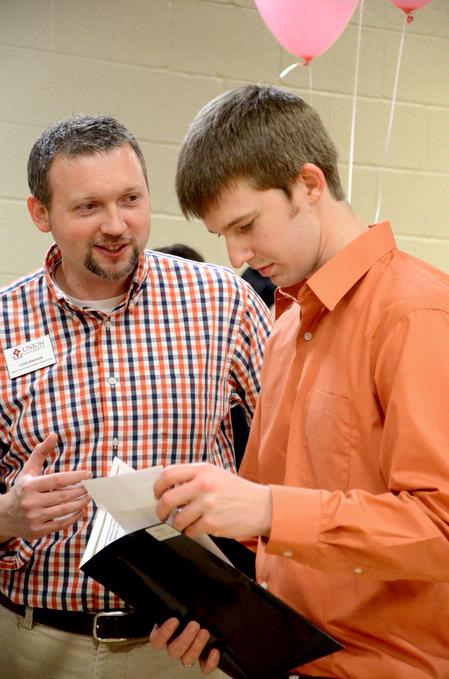 John Windham, director of recruitment, talks with a Scholar of Excellence perspective student during the welcome event in the Bowld Student Commons.