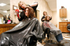 Shara Lynn Hunt dries Karen Martin's hair after cutting and coloring during her first week at Houston Salon & Co. In the background Livi Maynard is working on Sarah Hubbard's new do during a <i>Cardinal & Cream</i> makeover. - Photo by Kristen Nicole Sayres