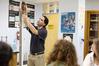 Fonsie Guilaran, associate professor of physics, shows students how to use the equipment for their acceleration lab assignment.  - Photo by Kristi McMurry