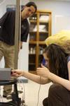 Fonsie Guilaran, associate professor of physics, watches as students collect the data for their acceleration experiment in physics lab. - Photo by Kristi McMurry
