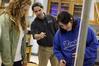 Fonsie Guilaran, associate professor of physics, shows students how to use the equipment for their lab experiment on acceleration.  - Photo by Kristi McMurry