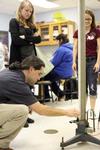 Fonsie Guilaran, associate professor of physics, helps students collect data for their lab experiment on acceleration. - Photo by Kristi McMurry