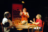 Molly Williams as Cassandra Hooper attempts to juggle sopapillas for Patrick Myers and Miranda Wallace as Marvin and Millie Standard in <i>You Have To Serve Somebody</i>. - Photo by Jim Veneman
