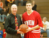 Senior guard Will Harris accepts a game ball from head coach Ralph Turner in recognition of his 1,000th career point with the Bulldogs. - Photo by Courtney Ross
