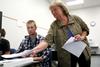 Anna Clifford, associate professor of education, hands a paper back to David Leisey, sophomore elementary education major, during instructional technology in the classroom. - Photo by Deanna Santangelo