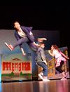 Sam Ritter leaps across stage as Chase Techentin and Kristen Voorhies dance in the background during the performance with the independent group "There and Back Again" at the 14th annual Variety Show. - Photo by Abigail Harris