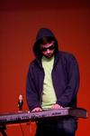Stephen Capps, junior biblical studies major, plays the keyboard with the Dr. Dockery bobble head on top at the 14th annual Variety Show. - Photo by Deanna Santangelo