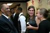Tony Dungy, Super Bowl winning coach, greets Amber Lovelady, senior political science, and Dionna Linn, freshman athletic training, during the Roy L. White Golf and Gala meet and greet time.  - Photo by Deanna Santangelo