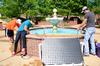 Engineering majors, Jacob Hodge, James Avery, and Chris Hayes observe the temperature change of the water while using a solar panel to heat the fountain. - Photo by Ebbie Davis