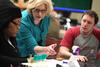 Cathy Huggins, director of biological laboratories, helps her students with an experiment in lab.  - Photo by Kristi McMurry