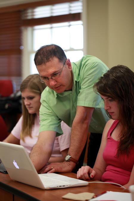Michael Salazar, associate professor of chemistry, helps his students with some P.Chem calculations. 