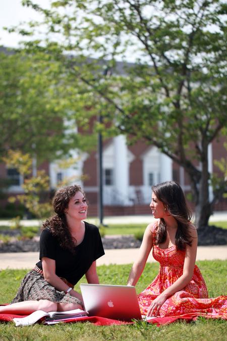 Hannah Strickland, junior elementary education major, and Claudia Velasco, sophomore accounting major, enjoy a nice day on campus. 