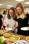 Stephanie Smith, sophomore ICS major, and Megan Miller, sophomore social work major, try the easy-to-make recipes at Food For Thought, hosted by Joelle Williams. - Photo by Deanna Santangelo