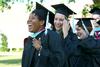5/21/11 - Nadia Barnard and Sara Boyd, master of urban education graduates, walk to the Great Lawn for spring graduation. - Deanna Santangelo