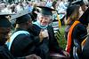 5/21/11 - Doctor of Education graduates, Momodou Keita and Mary Alice Marable congratulate each other on receiving their degrees during spring graduation. - Deanna Santangelo