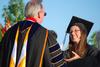Beth Spain, journalism major, receives her diploma from David S. Dockery, president of the university, during spring graduation. - Photo by Jacob Moore