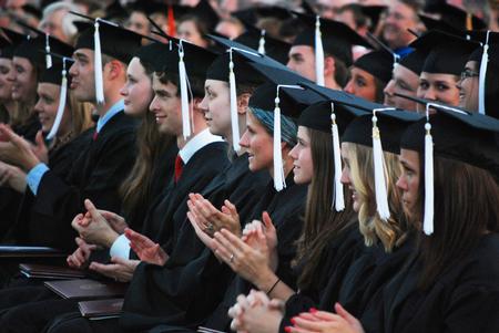 Graduates applaud during spring graduation on the Great Lawn.