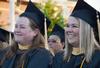 5/21/11 - Master of Social Work graduates Cyndy Galewski and Theresa Guthrey watch their fellow classmates receive their diplomas at spring graduation. - Victoria Stargel