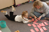 11/10/03 - Sophomore Kristen Lutrell, learning foundations major, makes flashcards with a student at Parkview Motessori during Day of Remembrance 2003. - Jonathan Blair