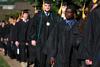 Tayo Adedokun, engineering graduate, walks with his fellow graduates to the Great Lawn for spring graduation. - Photo by Kristi McMurry