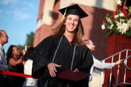 Elizabeth Whitsitt, psychology graduate, leaves the stage after receiving her degree at spring graduation.