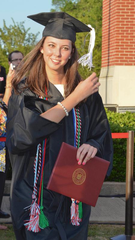 Katie Mohler, history graduate, leaves the stage after receiving her degree during spring graduation.
